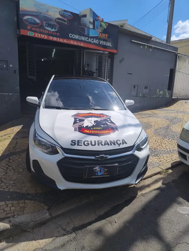 Carro branco com adesivagem de empresa de segurança